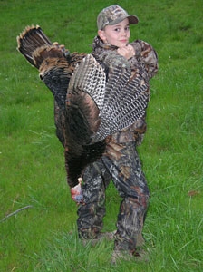 Hunter Pariani 10 poses with a shot turkey