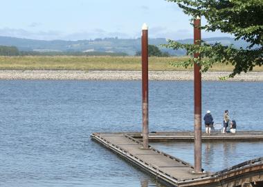 A family stands on a dock on the Gilbert River