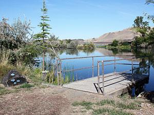 A fishing dock extends into McNary Pond
