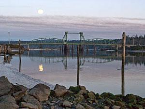 A photo of a bridge crossing the Coquille River.
