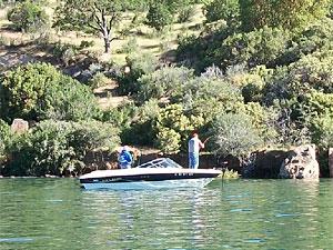 two people fish from a boat in Emigrant Lake