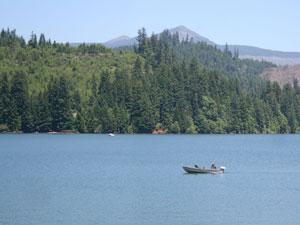 a small fishing boat sits in the middle of Foster Reservoir