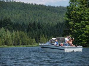 a family on a small motor boat on Timothy Lake