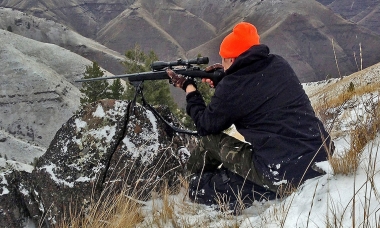 Rick Swart takes aim at an elk from his perch on the rim above Camp Creek in Northeast Oregon.
