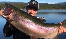 image of an angler holding a 32-inch rainbow trout