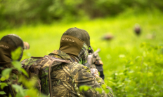 image of turkey hunter taking aim at a turkey