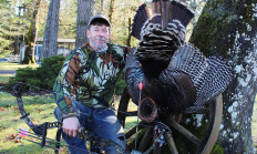 image of a successful bow hunter and his turkey