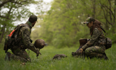 image of two hunters setting up turkey decoys