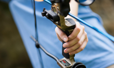 close up image a hand holding a bow