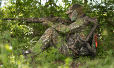 image of a turkey hunter with his gun resting on his knee