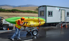 ODFW Aquatic Invasive Species Check Station spraying down kayaks on a boat trailer