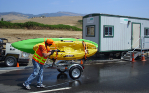 ODFW Aquatic Invasive Species Check Station spraying down kayaks on a boat trailer