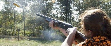 Photo of student firing a shotgun