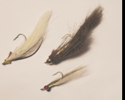 Photo of three flies mimicking minnows for bass fishing
