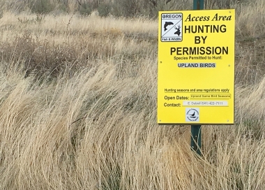 sign indicating the property is open to hunting with permission