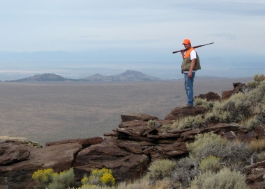 Hunter on top of canyon rim
