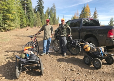 Two hunters show off their loaded mountain bikes and trailers before the set out on a deer hunt in NE Oregon.