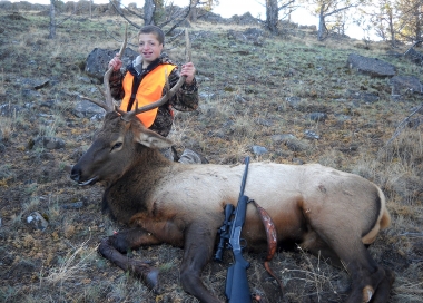 Young rifle hunter with his first bull elk taken near Madras.