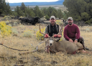 Two hunting brothers with a large mule deer taken near Summer Lake.