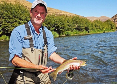 fly anglers holding a nice redband trout from Deschutes River