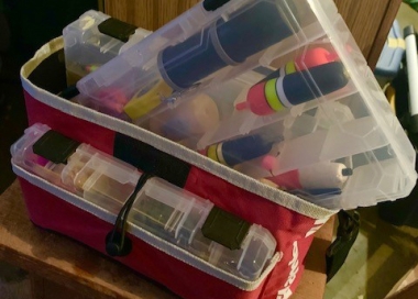 A fishing tackle box loaded with tackle.