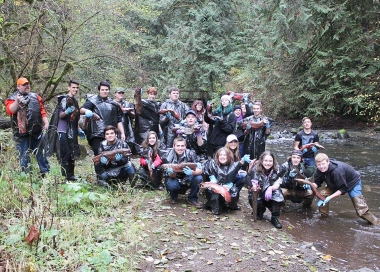 high school group holding salmon carcasses for stream enrichment
