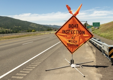 Boat Inspection at weigh station sign, orange rectangle on highway