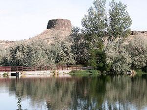 Hat Rock Pond is in the foreground and Hat Rock rises out of the background