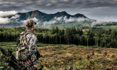 Bow hunter and mountains