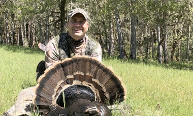 image of a hunter with a nice spring turkey