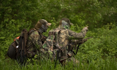 photo of two turkey hunters wearing lots of camo