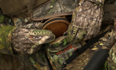image of hunter placing a pot call in a turkey hunting vest