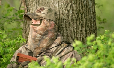 image of a turkey hunter set up in front of a large tree
