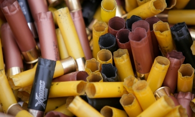 image of a bucket of spent shotgun shells