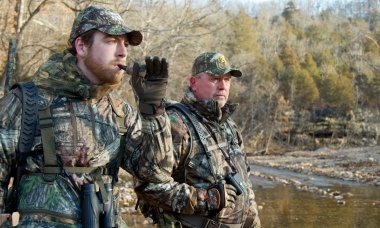 image of two hunters using a locator call to find turkeys