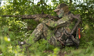 image of a turkey hunter with his gun resting on his knee