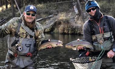 an image of two wading anglers holding nice rainbow trout from the Fall River