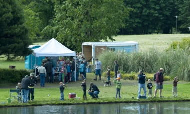 Several families fishing at a family fishing event