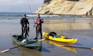two ocean kayakers on beach with rockfish