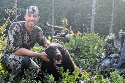 image of a rifle hunter with a spring bear
