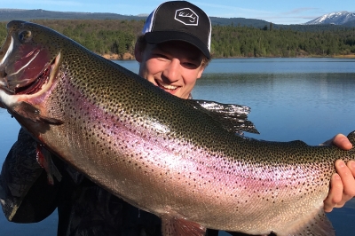 image of an angler holding a 32-inch rainbow trout