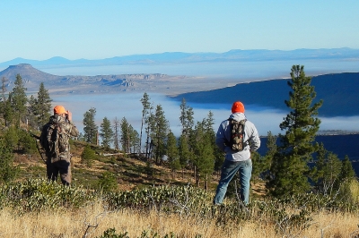 two hunters scanning landscape for game