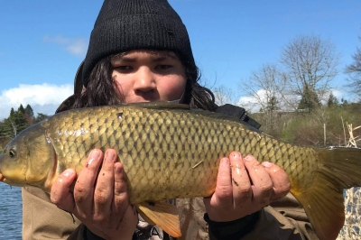 angler holding a large common carp