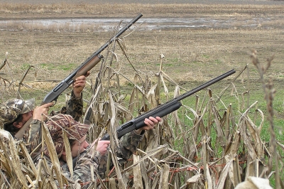 two duck hunters taking aim