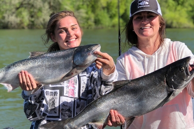 A mother-daughter showing off the salmon they caught