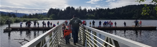 Families fish from a dock at Eckman Lake in Waldport 